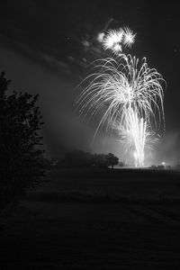 Low angle view of firework display at night