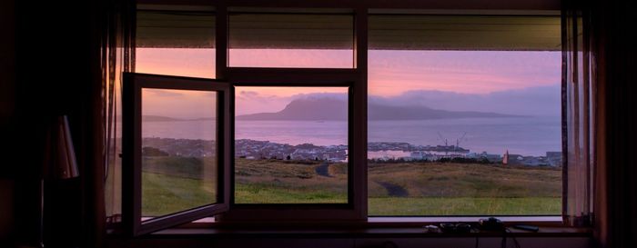 Scenic view of mountains seen through window