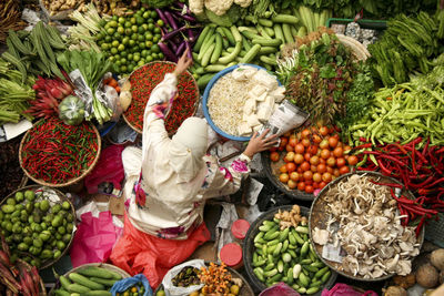 High angle view of woman selling vegetables at market