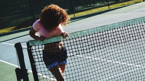 Woman behind tennis net