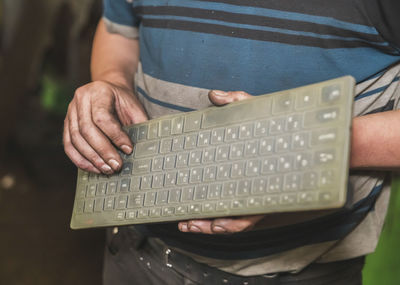 Midsection of man using sound mixer