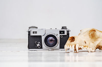 Close-up of camera against gray background