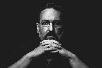 Portrait of man against black background