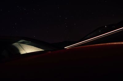 Car on road against sky at night