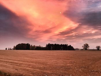 Scenic view of field against sky during sunset