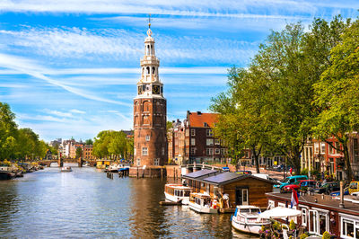 Canal amidst buildings against sky