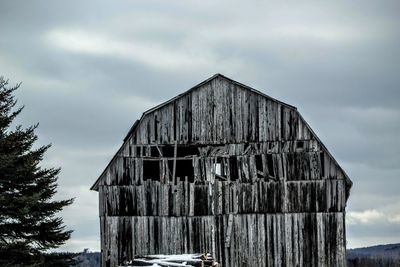 Low angle view of built structure against cloudy sky