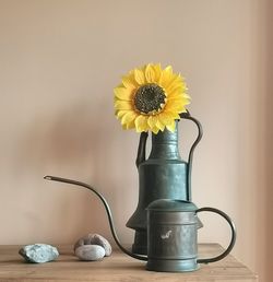 Close-up of yellow flower vase on table