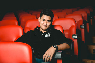 Portrait of smiling young man sitting on seat