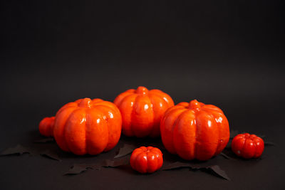 Close-up of oranges on table against black background