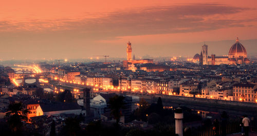 High angle view of illuminated cityscape against sky during sunset