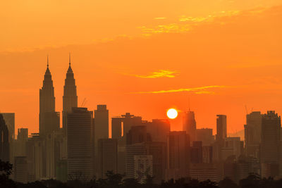 Modern buildings in city during sunset