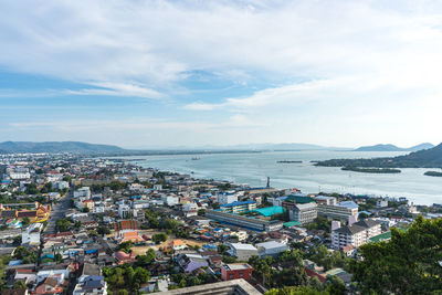 High angle view of city by sea against sky