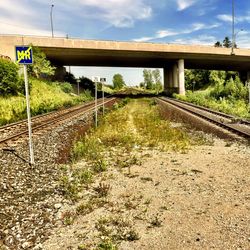 Railroad track against cloudy sky