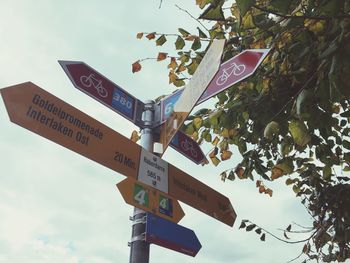 Low angle view of road sign against sky