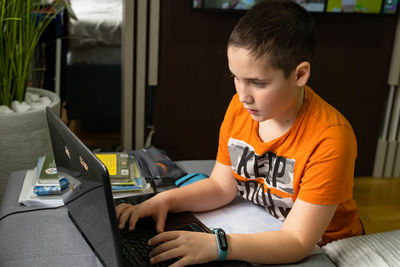 Boy using laptop at home