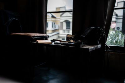 Close-up of camera on table by window