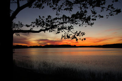 Scenic view of lake against romantic sky at sunset