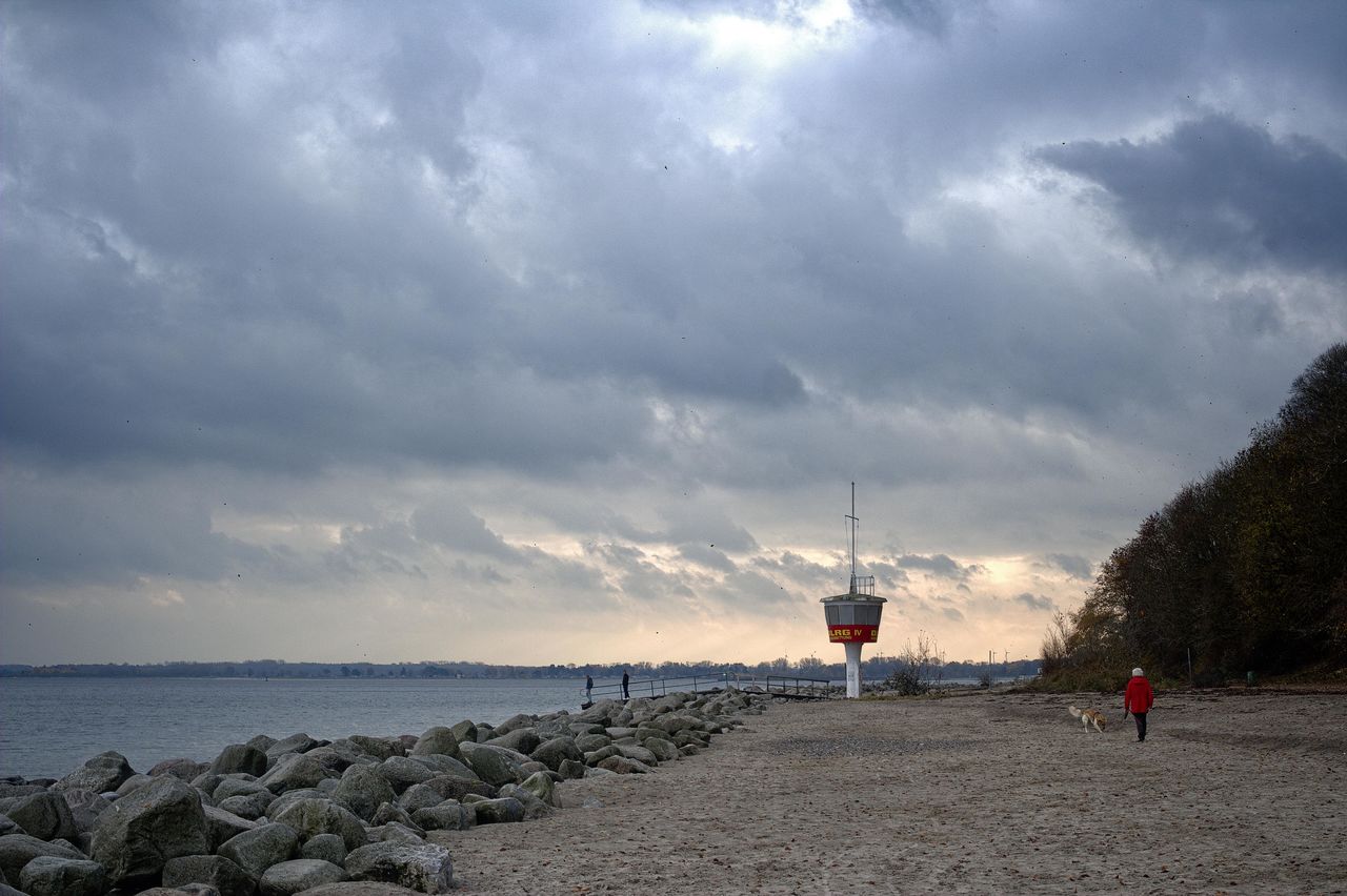 LIGHTHOUSE AMIDST SEA AGAINST SKY