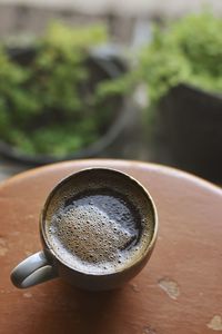 High angle view of brewed coffee in a mug in warm tone
