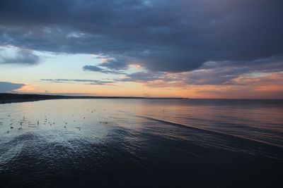 Scenic view of sea against sky at sunset