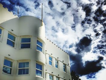 Low angle view of building against cloudy sky