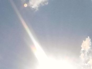 Low angle view of sun in sky
