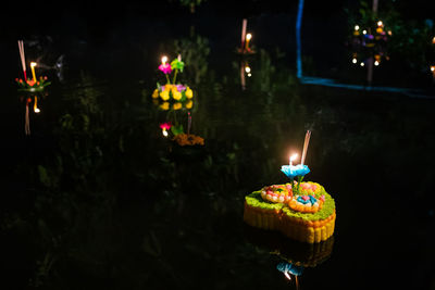 Illuminated candles on birthday cake