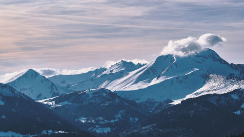 Scenic view of snowcapped mountains against sky during winter