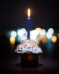 Close-up of lit candles on birthday cake