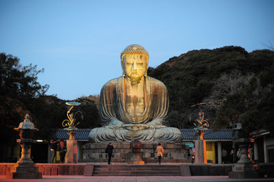 Statue of temple against building