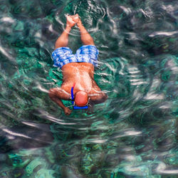 High angle view of shirtless man in swimming pool