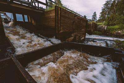 High angle view of dam by canal during winter