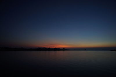 Scenic view of lake against romantic sky at sunset