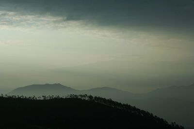 Scenic view of silhouette mountains against sky at dusk