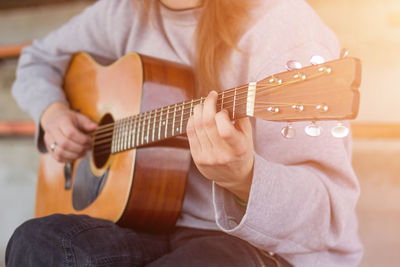 Close-up of man playing guitar