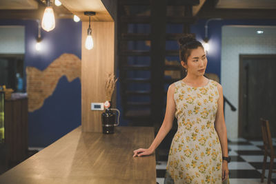 Young woman looking away at restaurant