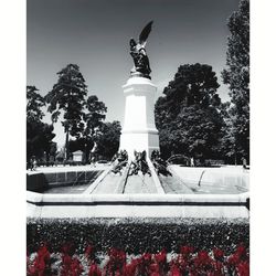 Statue by trees against sky