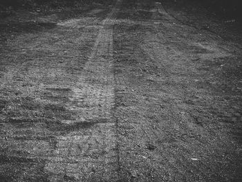 High angle view of tire tracks on road