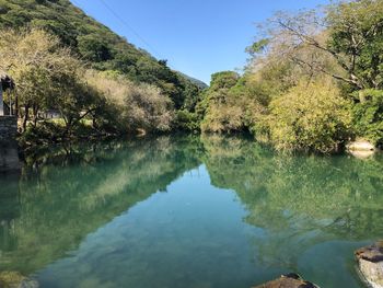 Scenic view of lake against clear blue sky