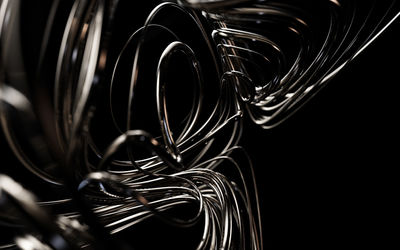 Close-up of spiral metal against black background