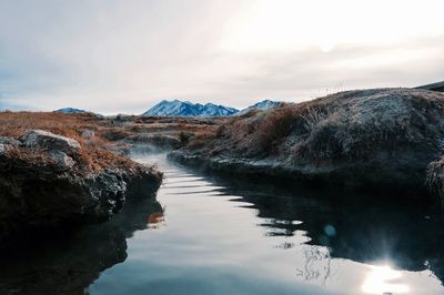 Scenic view of lake and mountains against sky