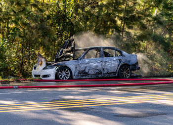 Burned out wreck of car still smoking while firefighters were still on scene in creedmor, nc