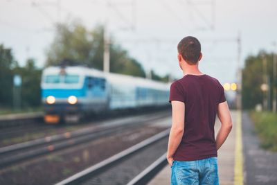 Rear view of man waiting in the railway station