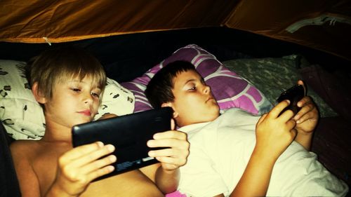 Boys playing in bed
