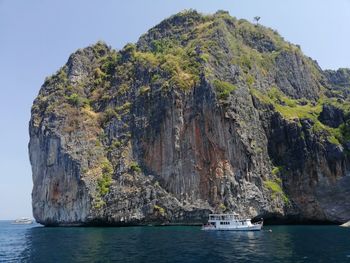 Scenic view of rock formation in sea against sky