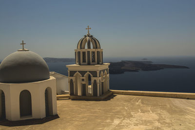 Cathedral by sea against clear sky