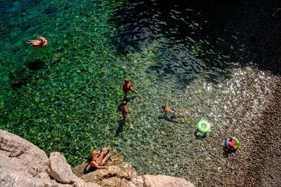 High angle view of children playing in lake