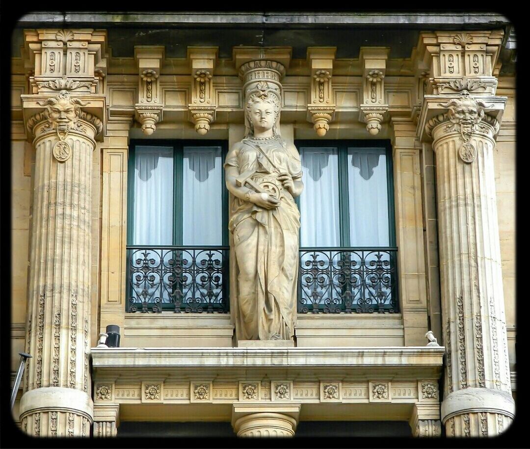 architecture, built structure, art and craft, building exterior, art, window, human representation, statue, creativity, low angle view, sculpture, ornate, carving - craft product, architectural column, history, building, facade, arch, column