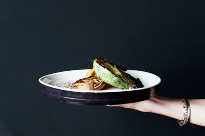 Cropped hand of person holding food